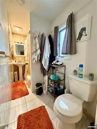 a bathroom with a sink toilet and mirror
