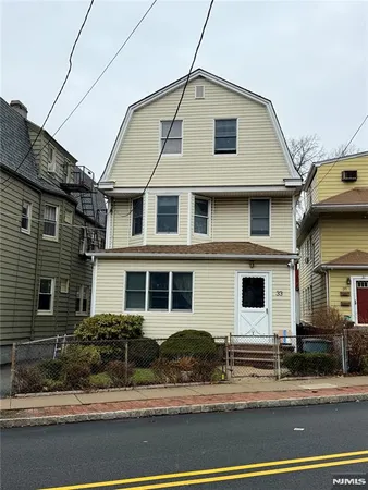 a brick house that has a street sign on it