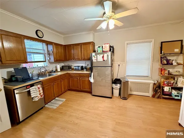 a kitchen with a refrigerator and a stove top oven