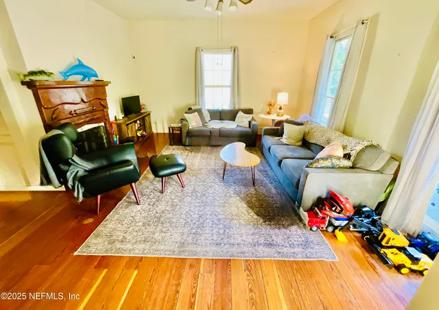 a living room with furniture a fireplace and a table