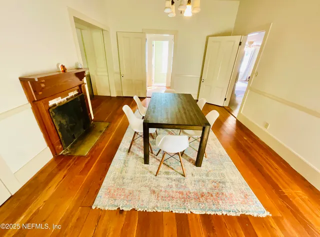 a view of a kitchen with stainless steel appliances wooden floor and a window