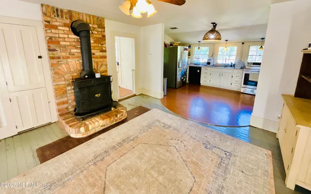 a kitchen with stainless steel appliances a refrigerator sink and white cabinets