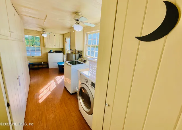 a very nice looking room with a large bed and wooden floor