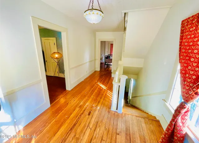a bathroom with a sink and mirror with bathtub