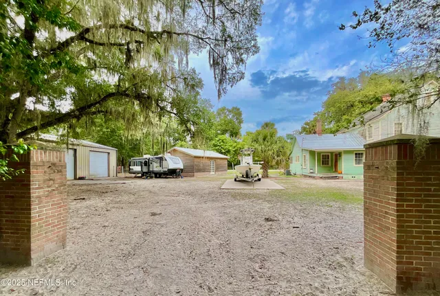 a view of a chairs and table in patio with umbrella