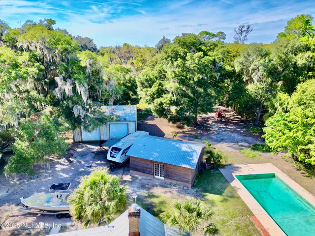 a view of a house with pool yard and a yard