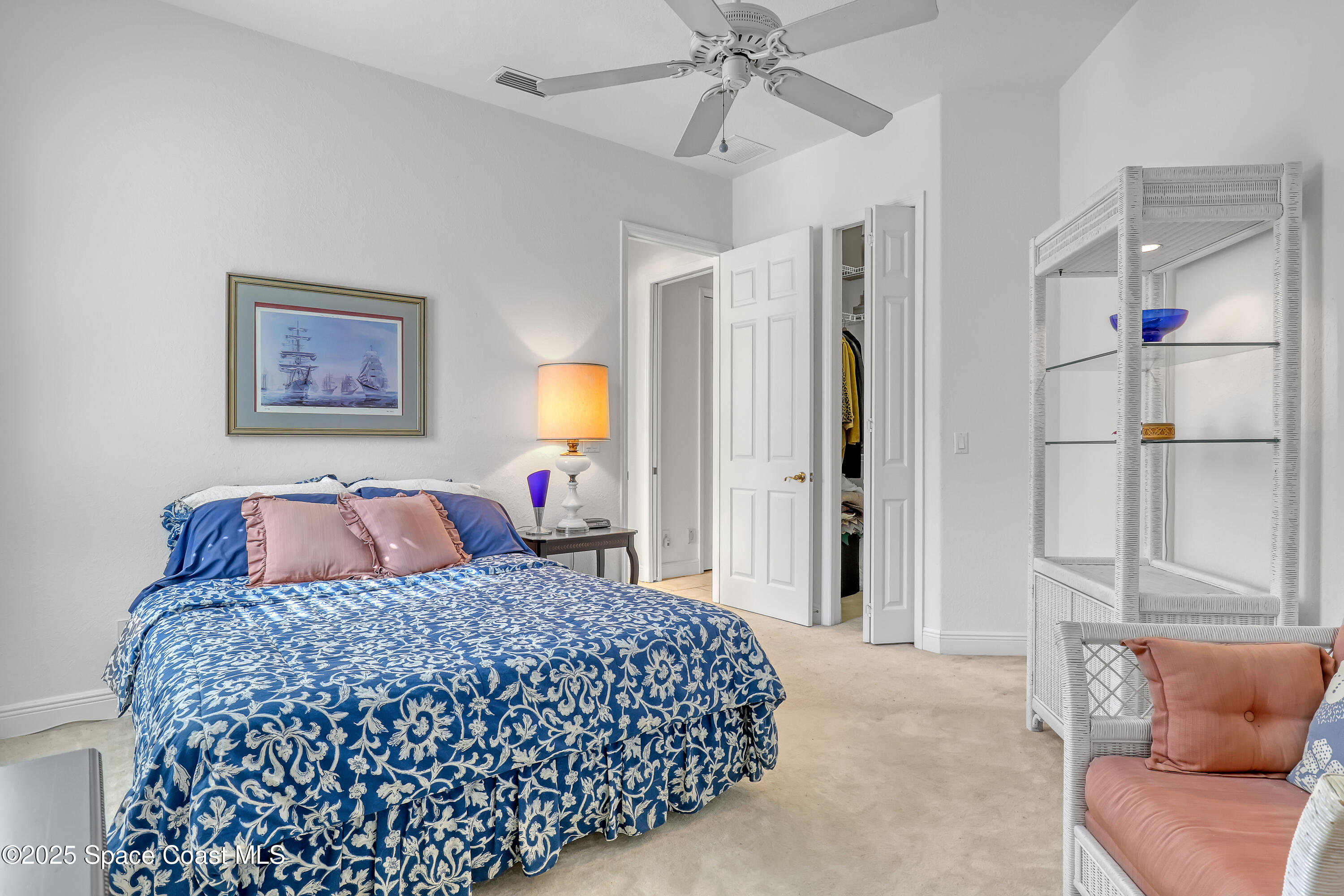813 Hogan Way Melbourne, FL 32940 - Photo 22 of 50 a bedroom with a large bed and a chandelier