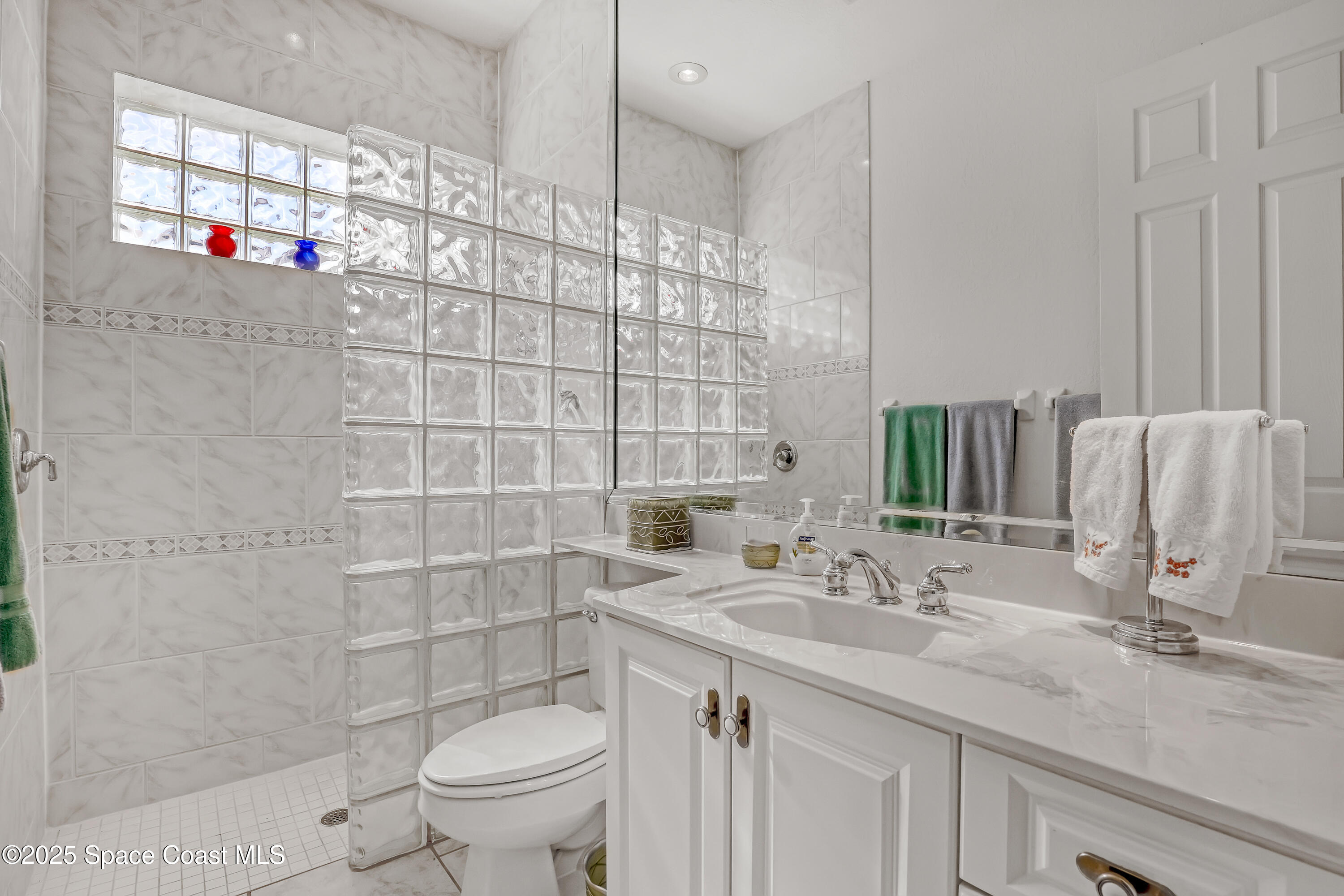 813 Hogan Way Melbourne, FL 32940 - Photo 23 of 50 a bathroom with a sink toilet and a shower