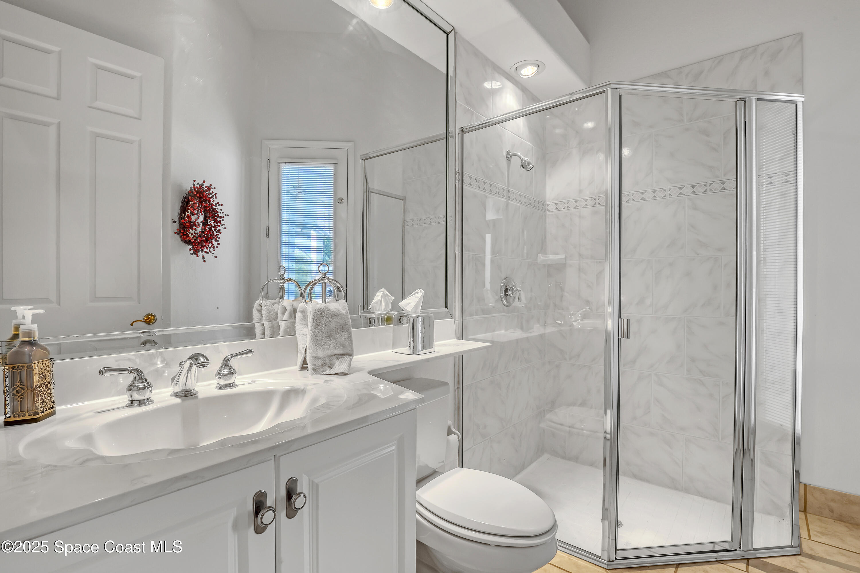 813 Hogan Way Melbourne, FL 32940 - Photo 26 of 50 a bathroom with a granite countertop sink a toilet and shower