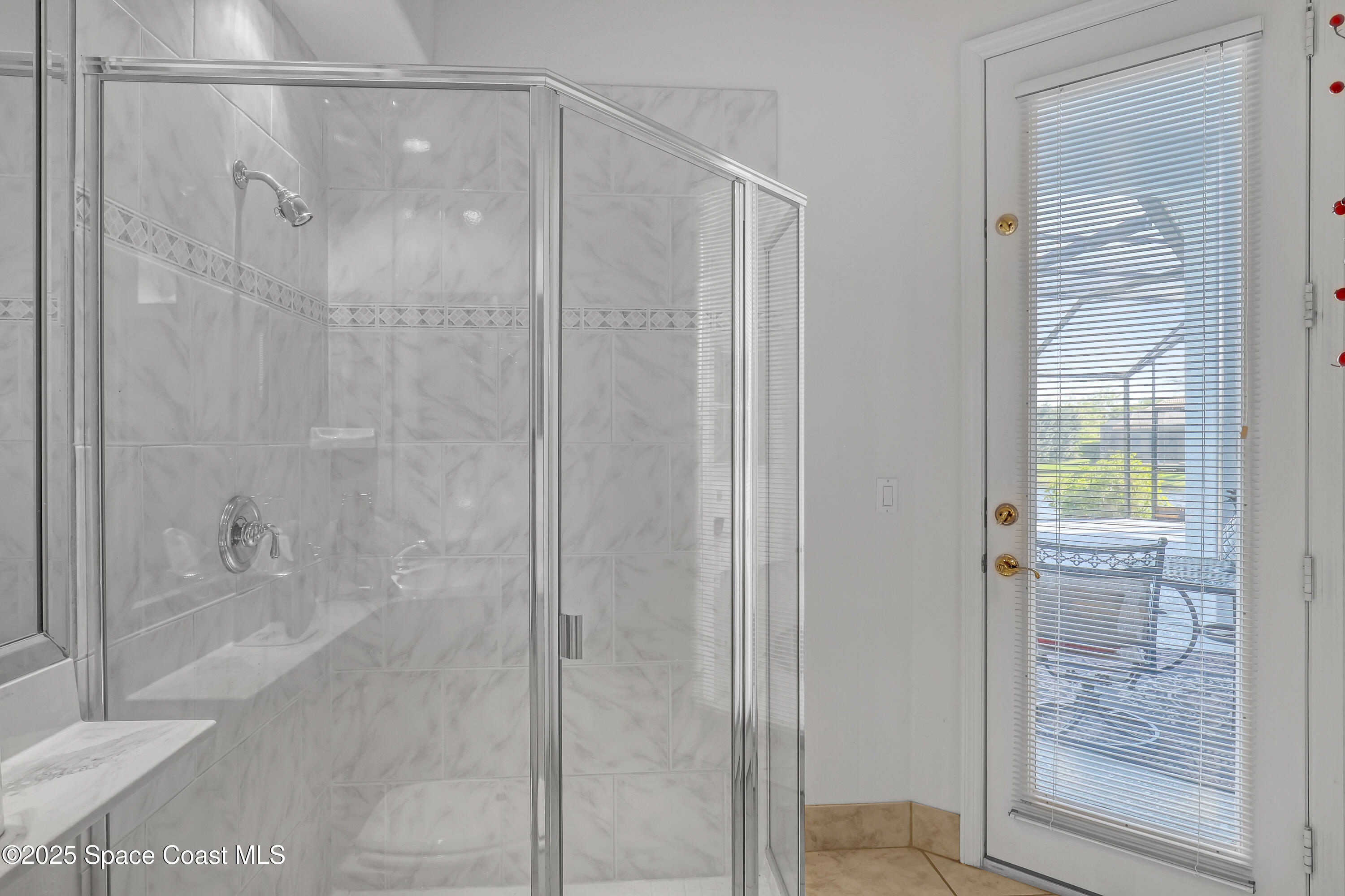 813 Hogan Way Melbourne, FL 32940 - Photo 27 of 50 a bathroom with a glass shower door