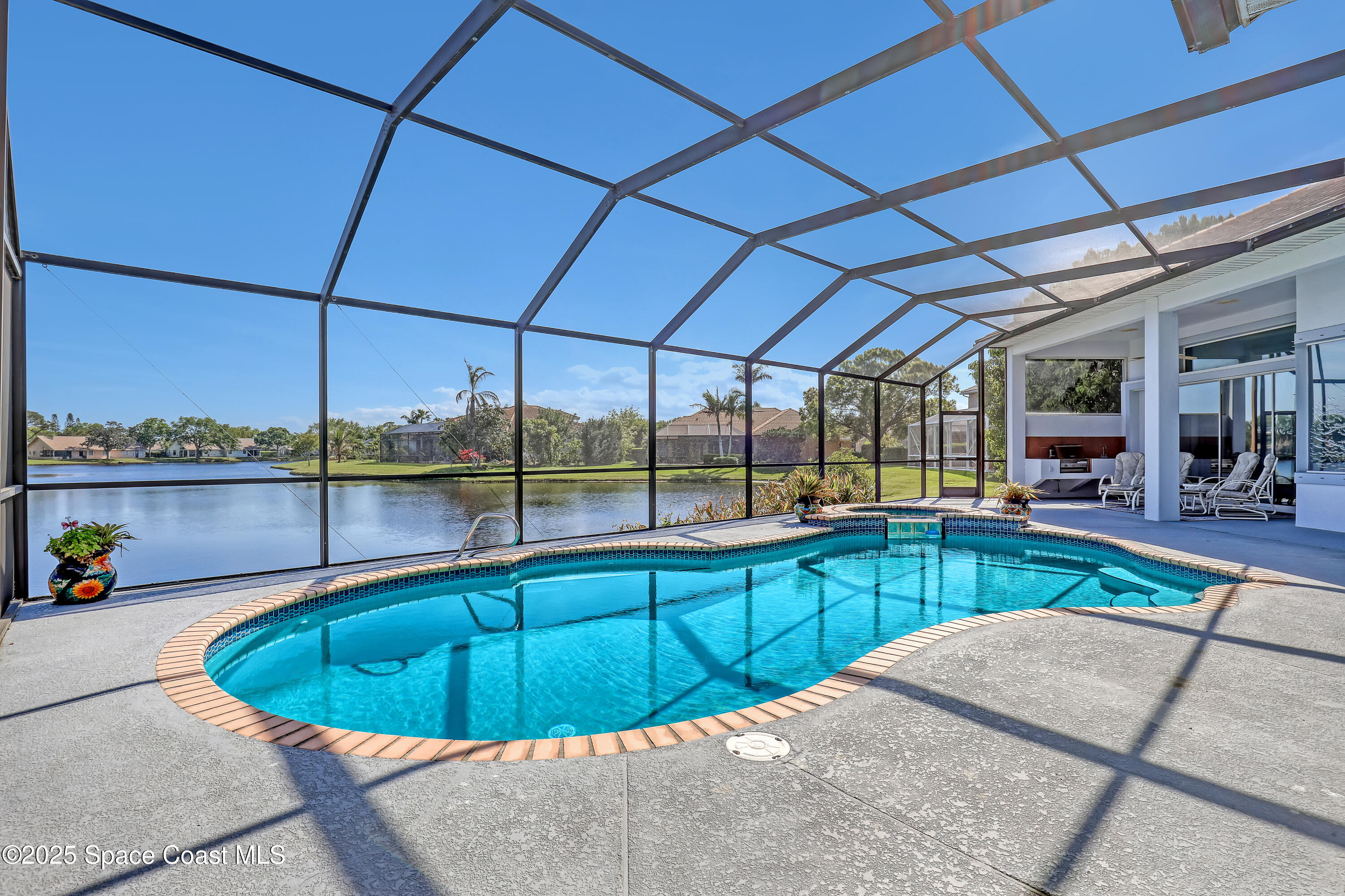 813 Hogan Way Melbourne, FL 32940 - Photo 33 of 50 a kitchen with a sink and wooden cabinets
