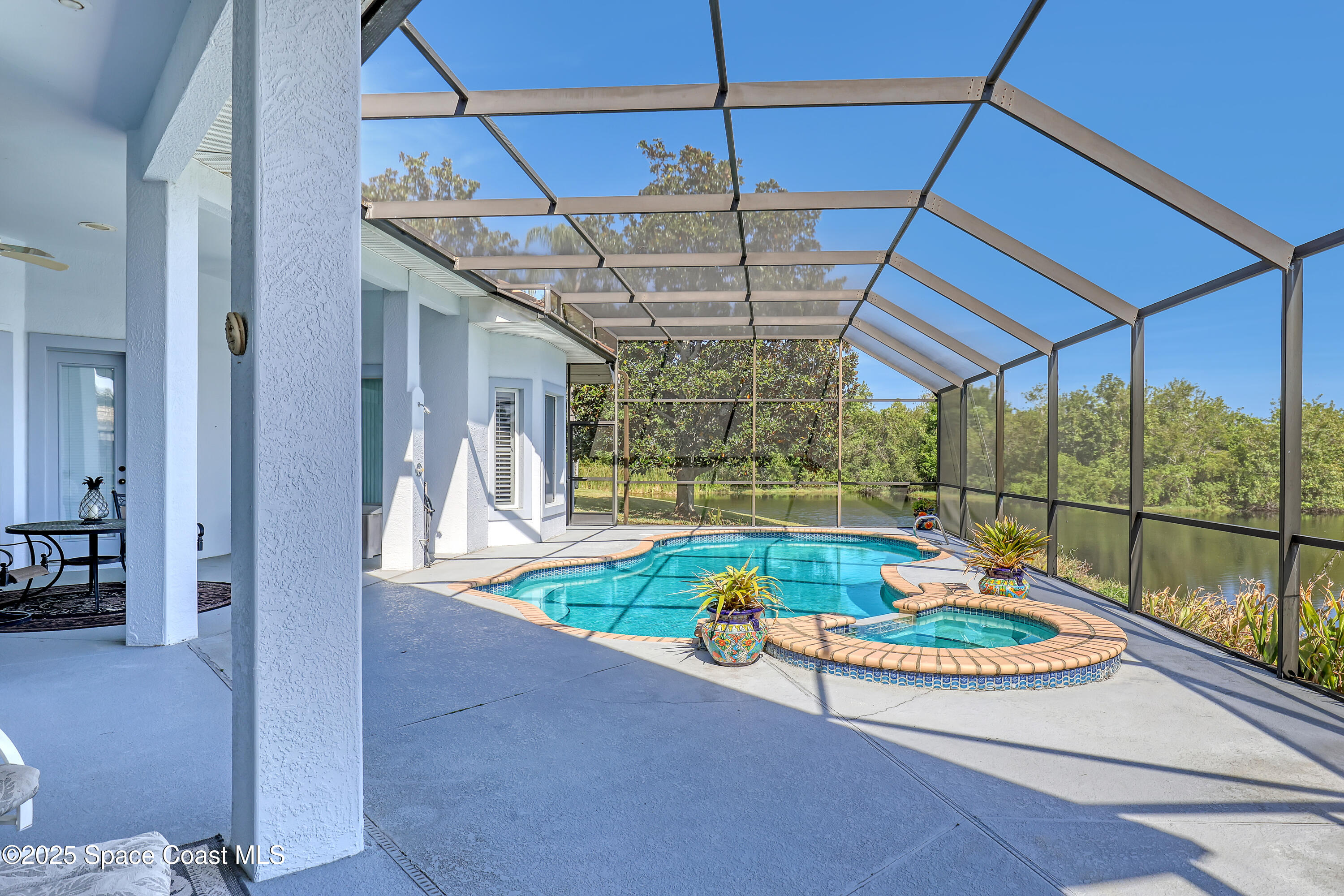 813 Hogan Way Melbourne, FL 32940 - Photo 34 of 50 a view of a patio with a table and chairs