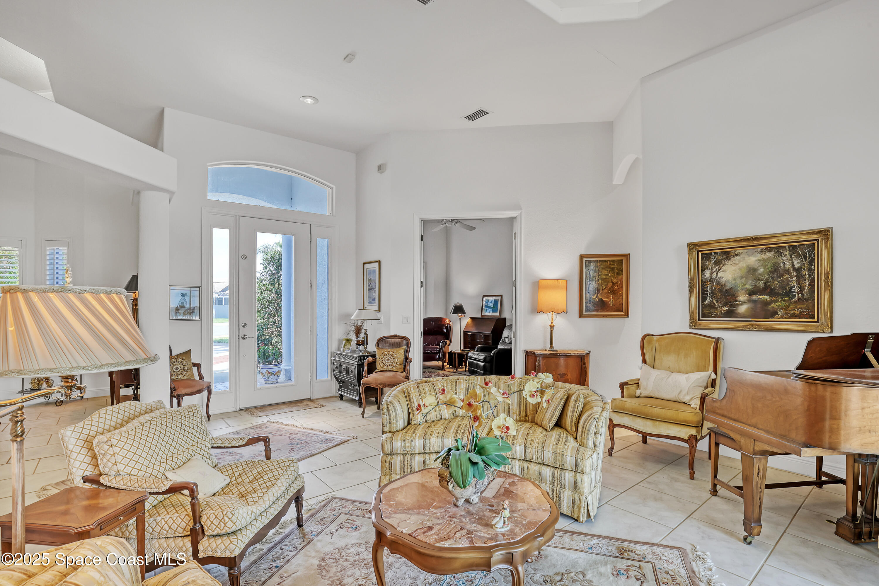 813 Hogan Way Melbourne, FL 32940 - Photo 7 of 50 a living room with furniture and a wooden floor