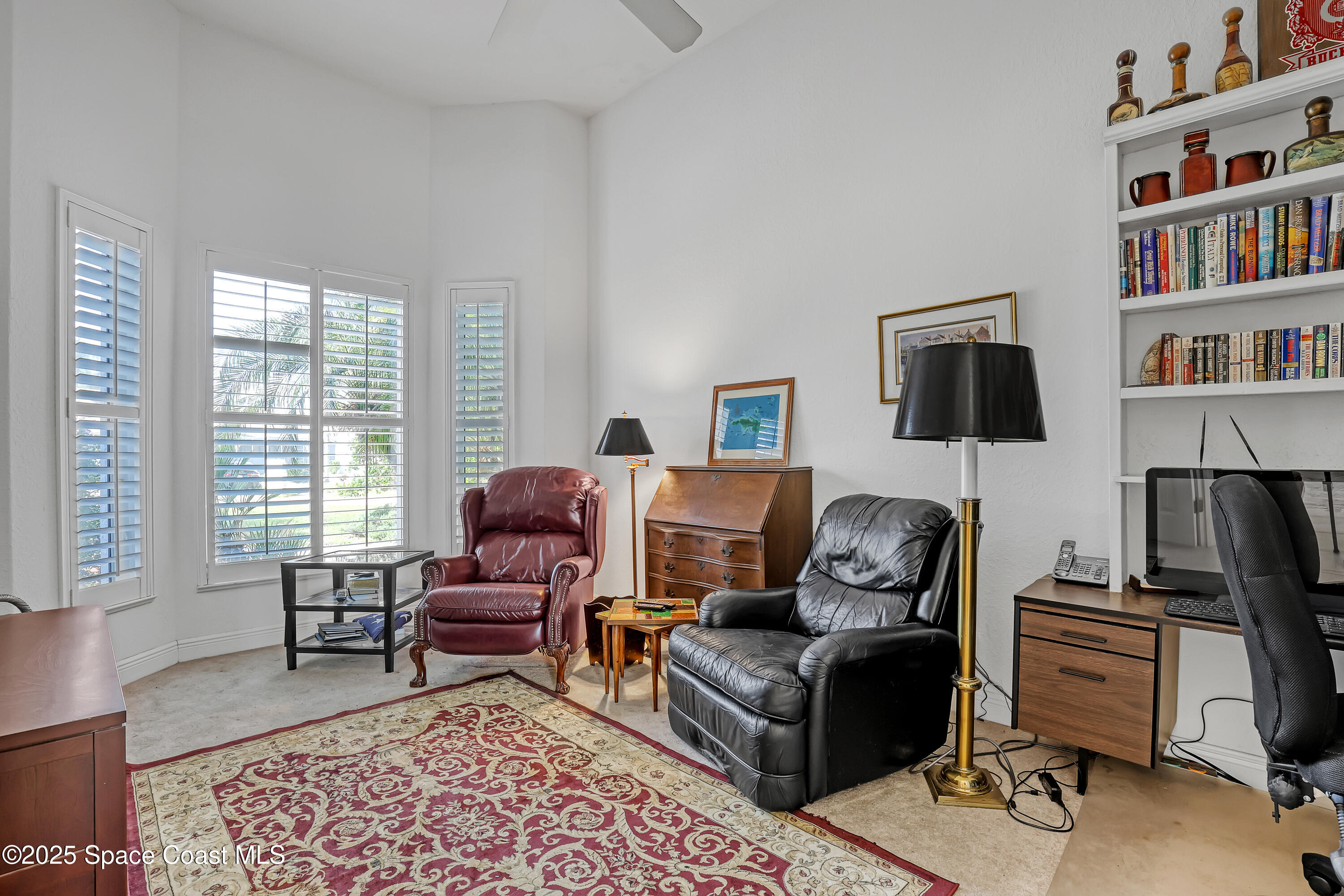 813 Hogan Way Melbourne, FL 32940 - Photo 8 of 50 a living room with furniture window and a flat screen tv