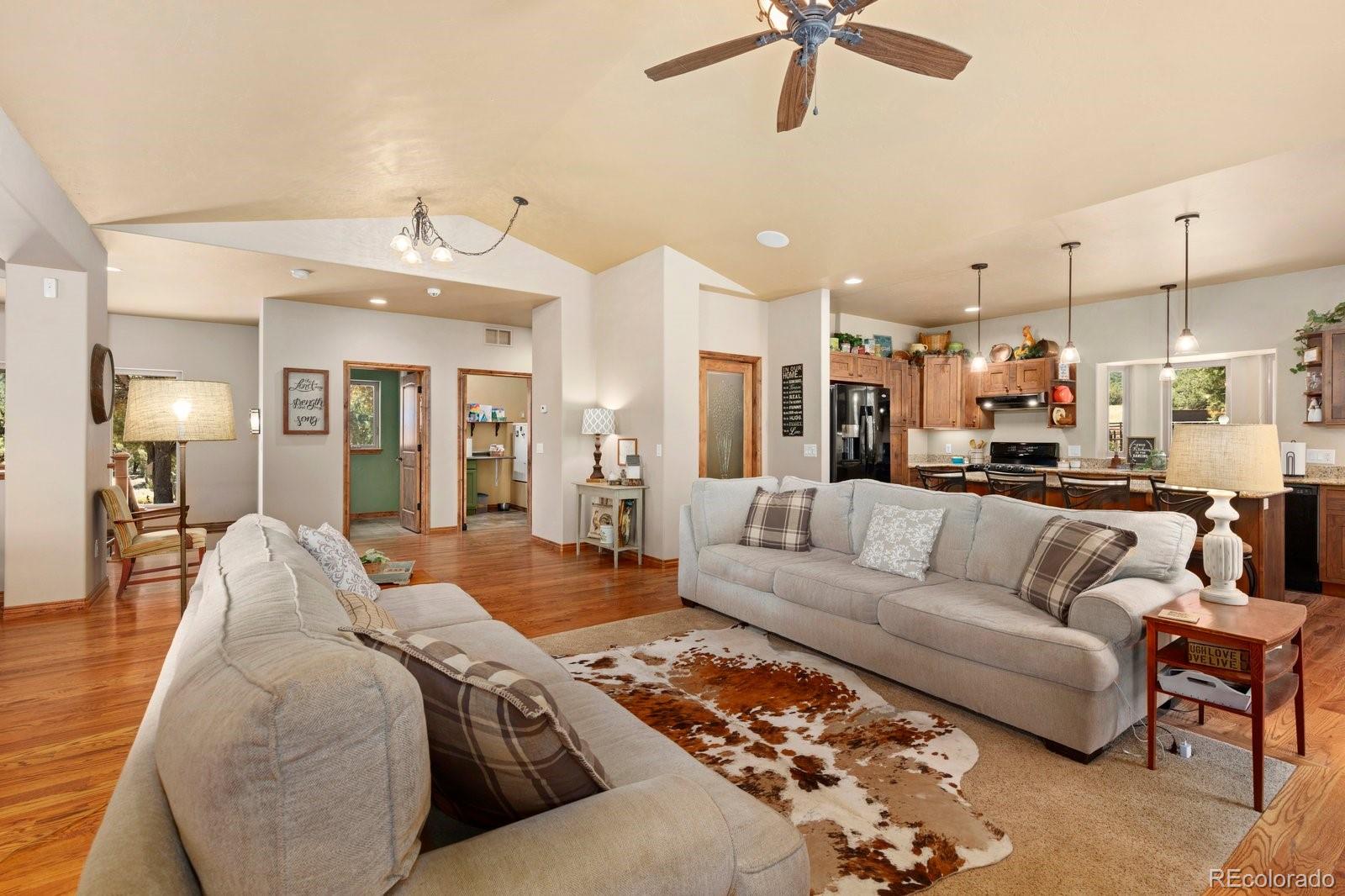 990 Hamilton Creek Road Coaldale, CO 81222 - Photo 10 of 49 a living room with furniture and a chandelier