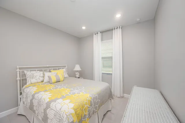 a bedroom with a bed and a night stand