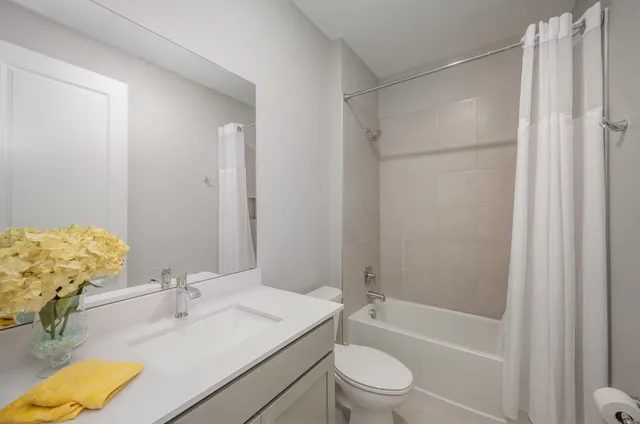 a bathroom with a granite countertop sink toilet and shower