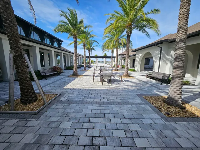 a view of a house with backyard and sitting area