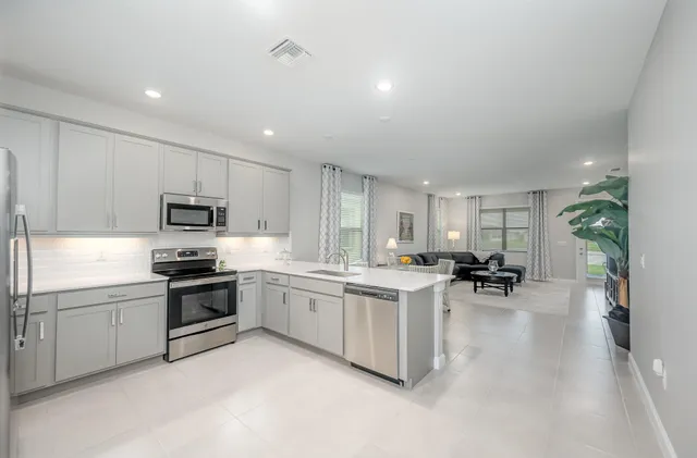 a kitchen with sink and cabinets