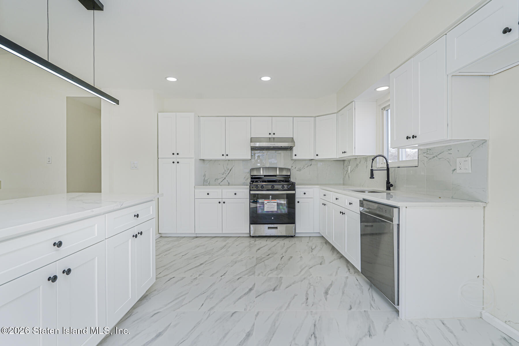 39 Commerce Street Staten Island, NY 10314 - Photo 14 of 49 a kitchen with granite countertop white cabinets and stainless steel appliances