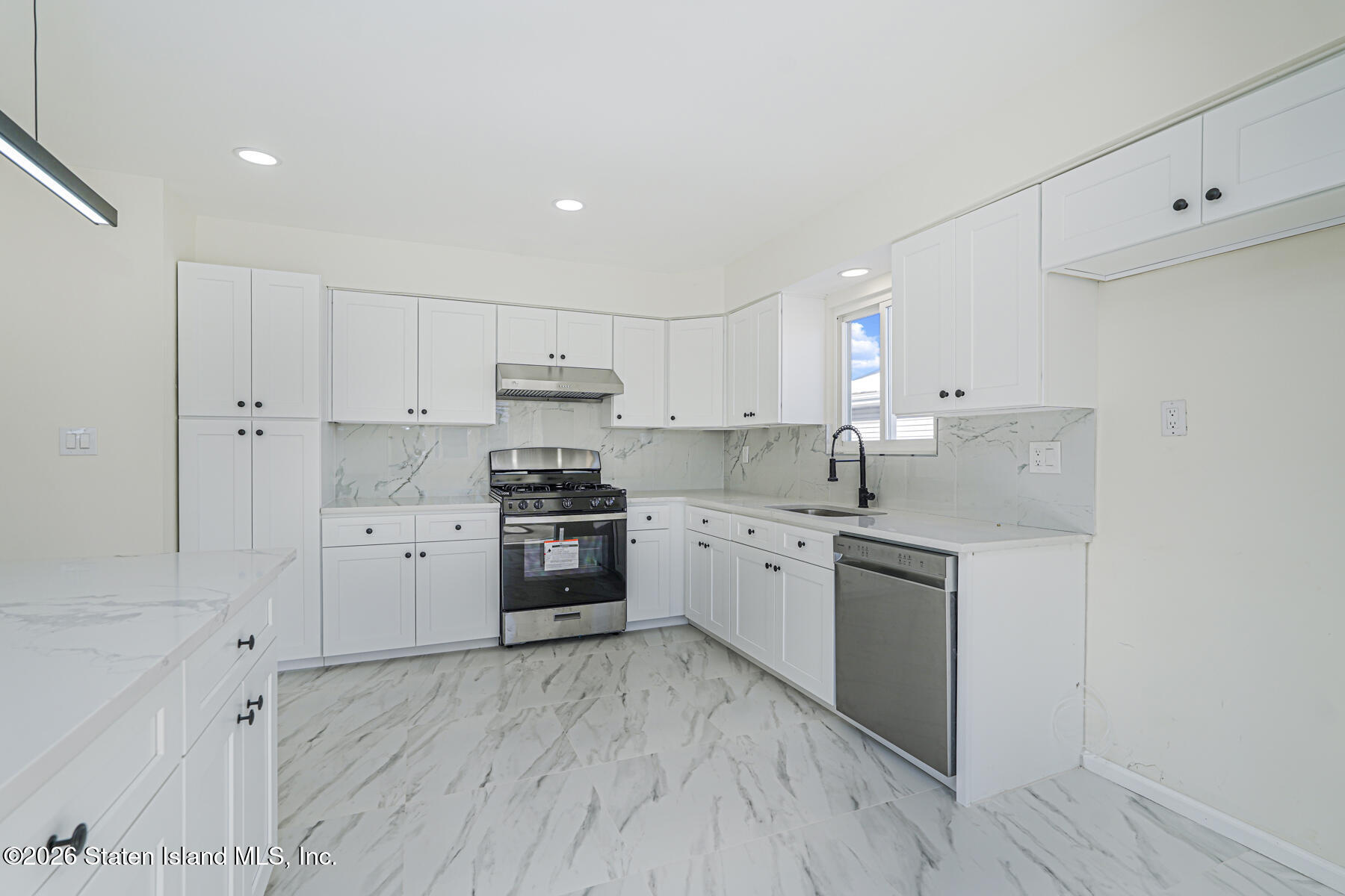 39 Commerce Street Staten Island, NY 10314 - Photo 15 of 49 a kitchen with granite countertop white cabinets and stainless steel appliances