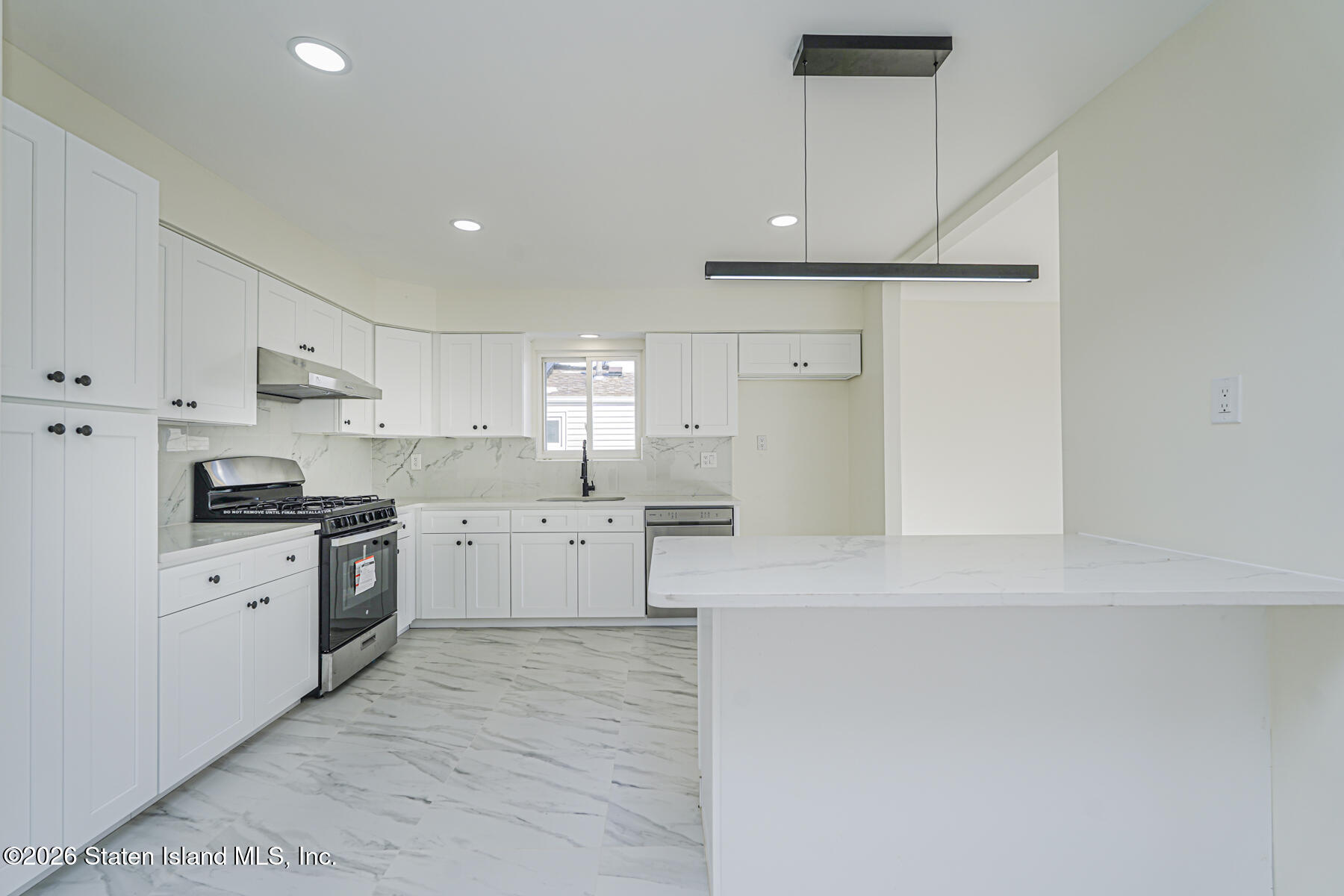 39 Commerce Street Staten Island, NY 10314 - Photo 17 of 49 a kitchen with stainless steel appliances a refrigerator sink and cabinets
