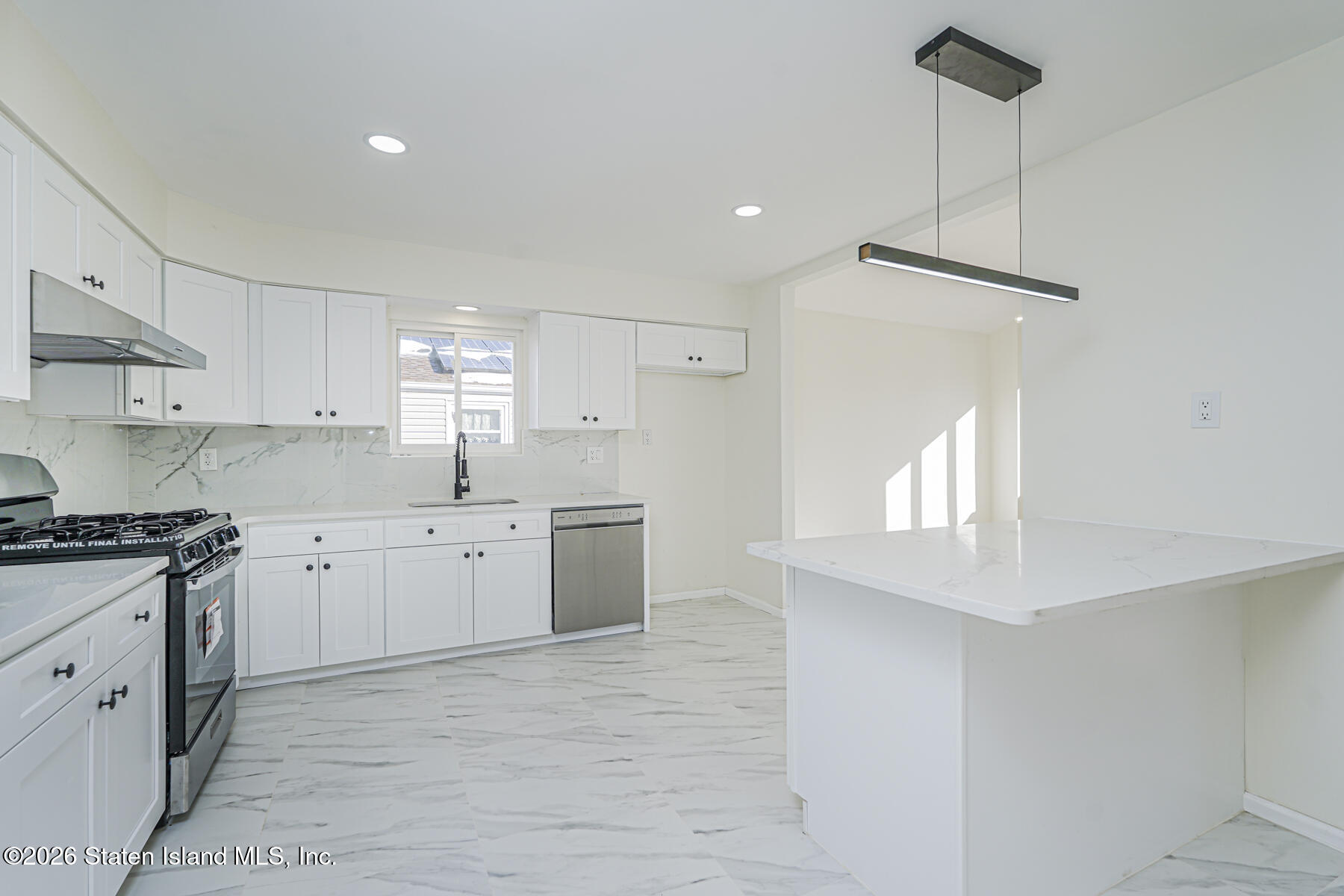 39 Commerce Street Staten Island, NY 10314 - Photo 18 of 49 a kitchen with a sink window and cabinets