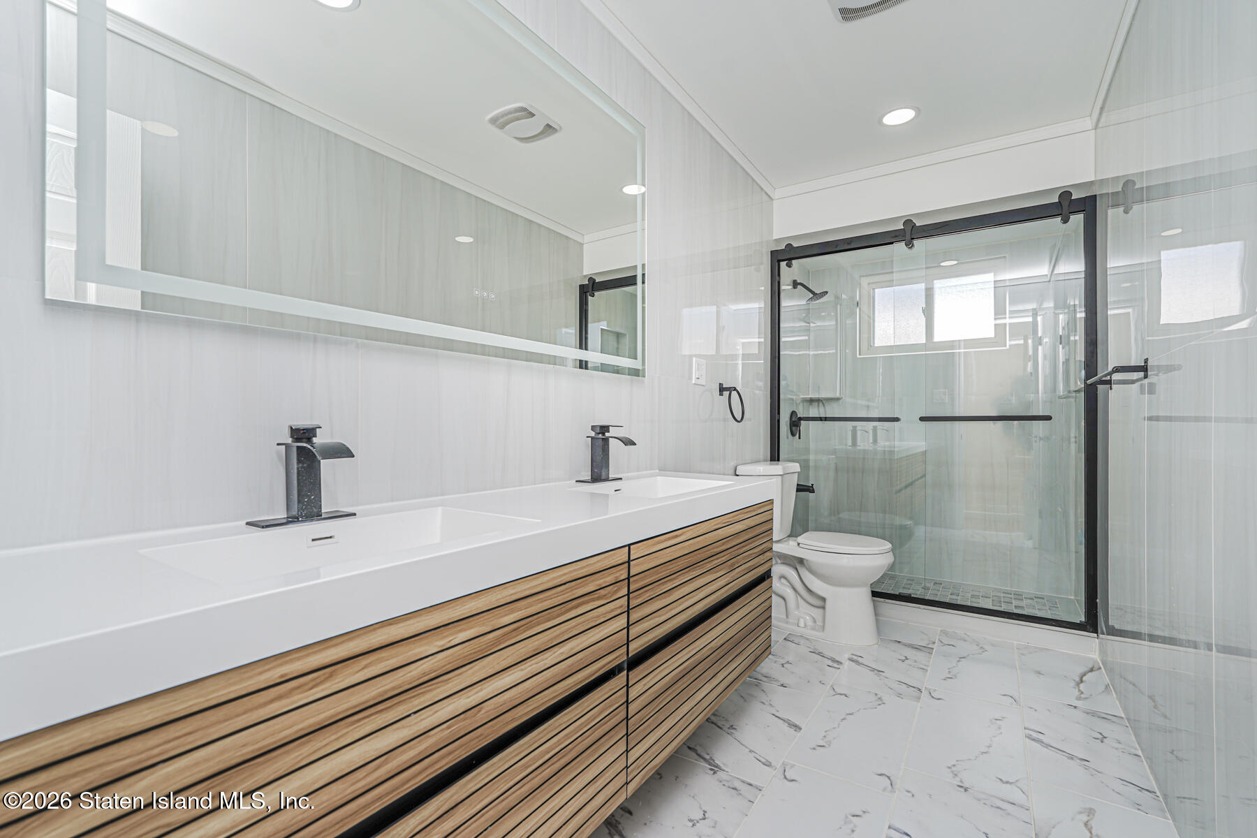 39 Commerce Street Staten Island, NY 10314 - Photo 19 of 49 a bathroom with a double vanity sink toilet and shower