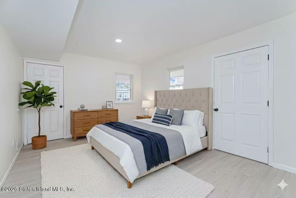 39 Commerce Street Staten Island, NY 10314 - Photo 21 of 49 a bedroom with a bed and a potted plant