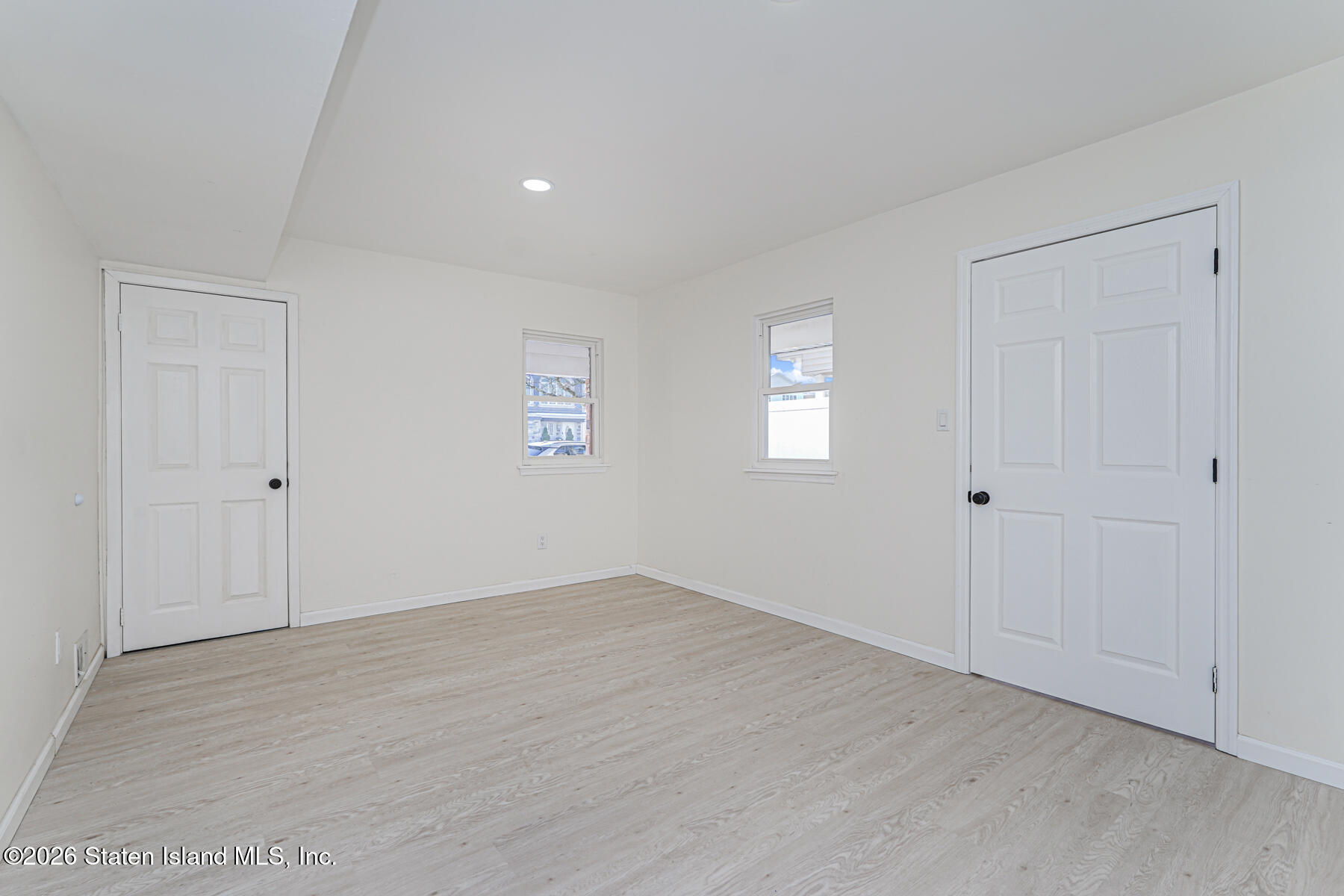 39 Commerce Street Staten Island, NY 10314 - Photo 22 of 49 a view of an empty room with wooden floor and a window