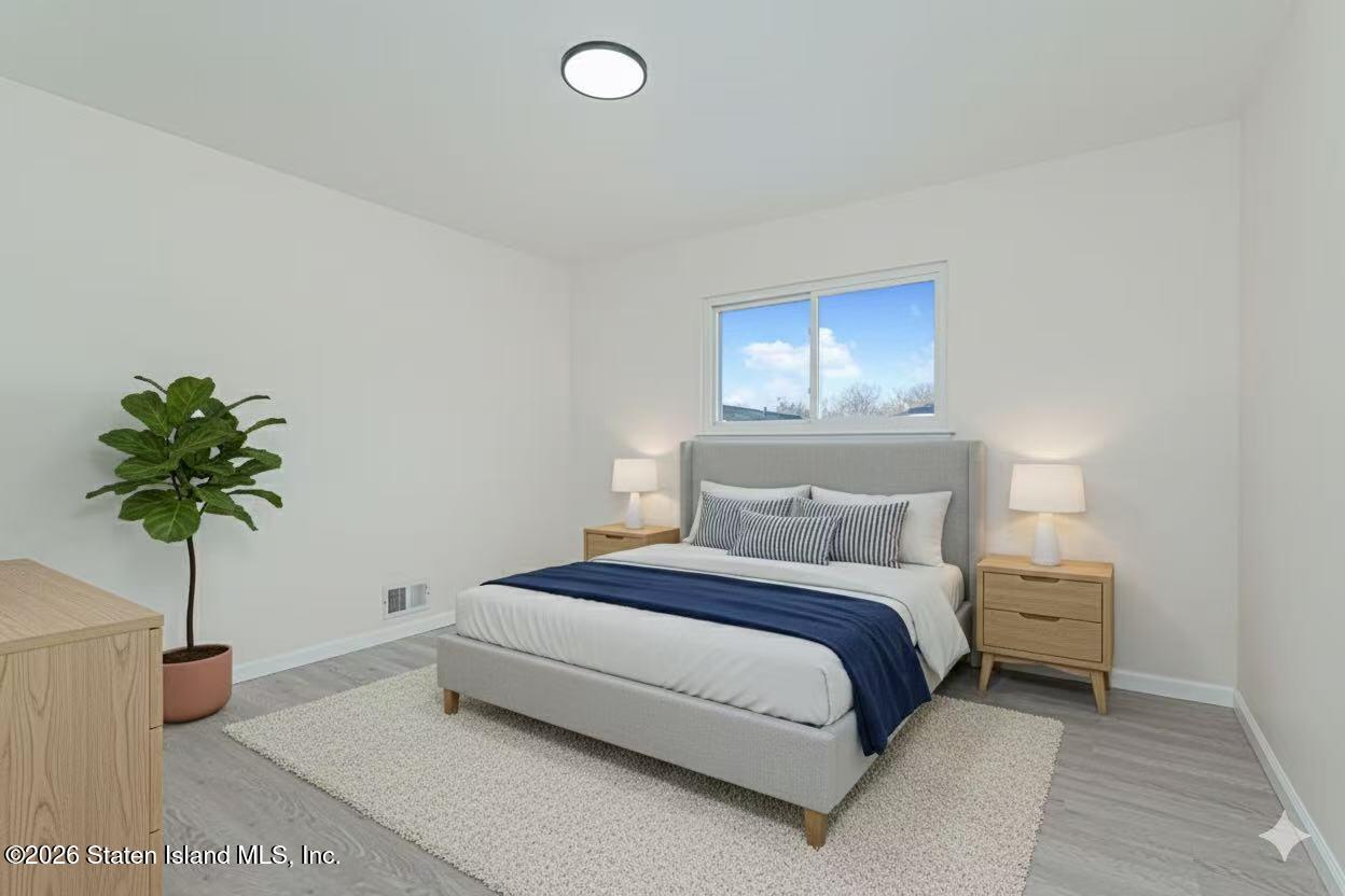 39 Commerce Street Staten Island, NY 10314 - Photo 26 of 49 a bedroom with a bed and a potted plant