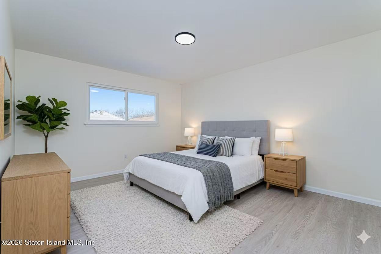 39 Commerce Street Staten Island, NY 10314 - Photo 29 of 49 a bedroom with a bed and a potted plant
