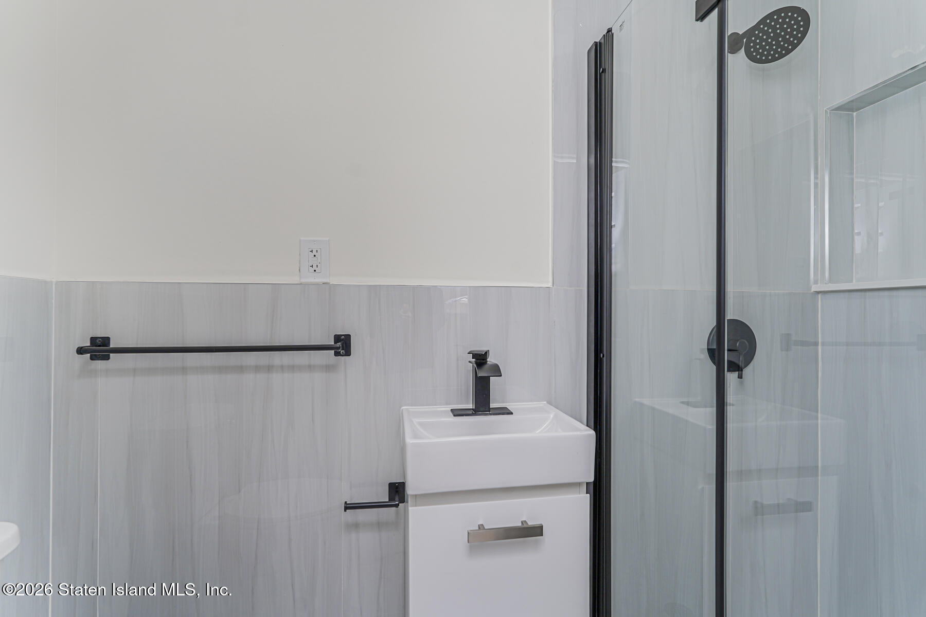 39 Commerce Street Staten Island, NY 10314 - Photo 33 of 49 a bathroom with a sink and mirror
