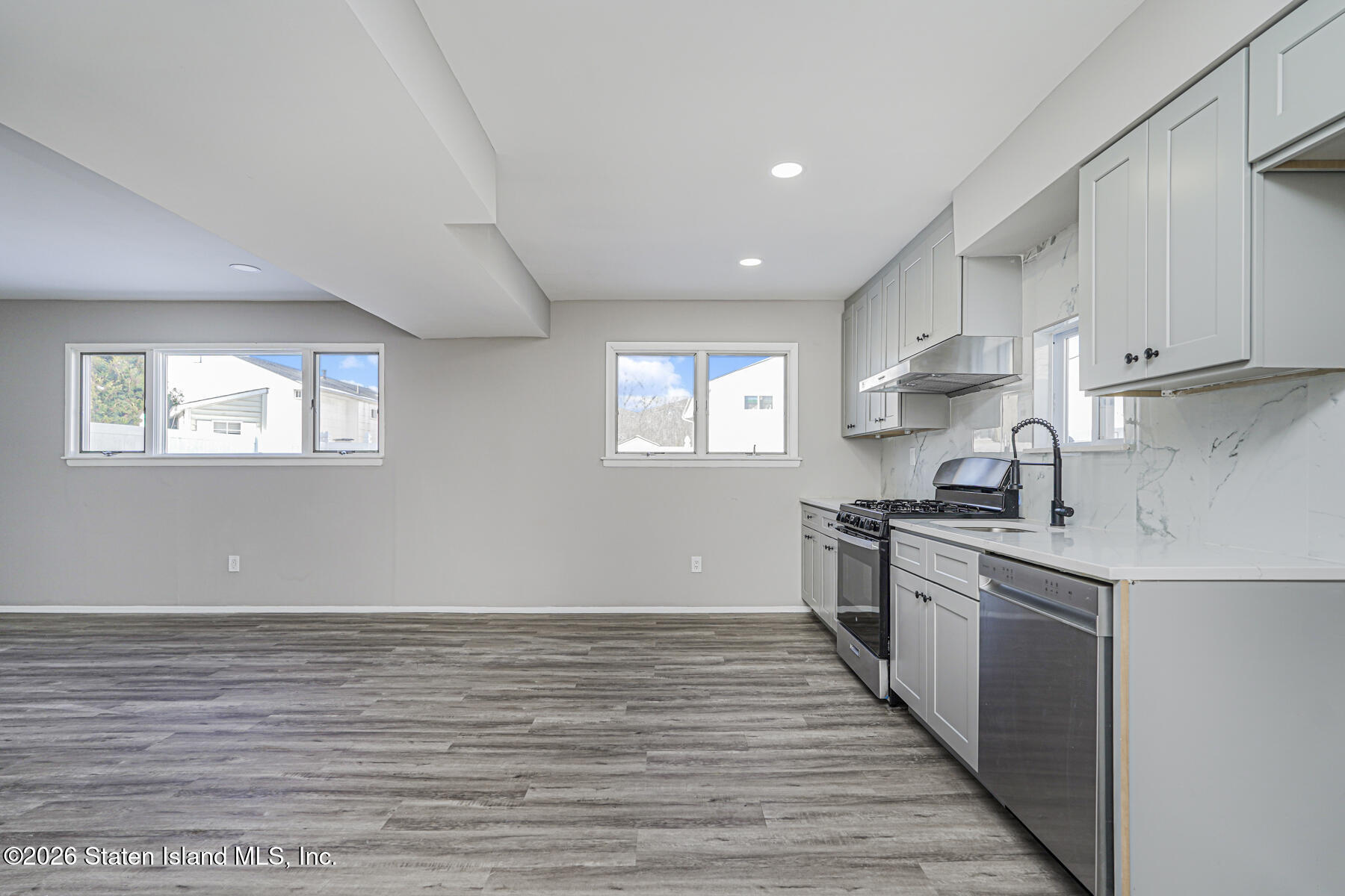 39 Commerce Street Staten Island, NY 10314 - Photo 39 of 49 a kitchen with stainless steel appliances granite countertop a stove a sink and white cabinets