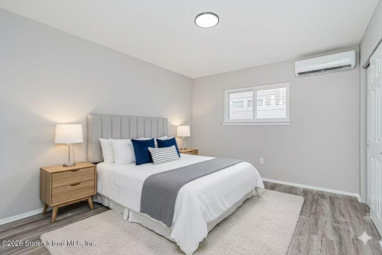 39 Commerce Street Staten Island, NY 10314 - Photo 42 of 49 a bedroom with a bed and a night stand