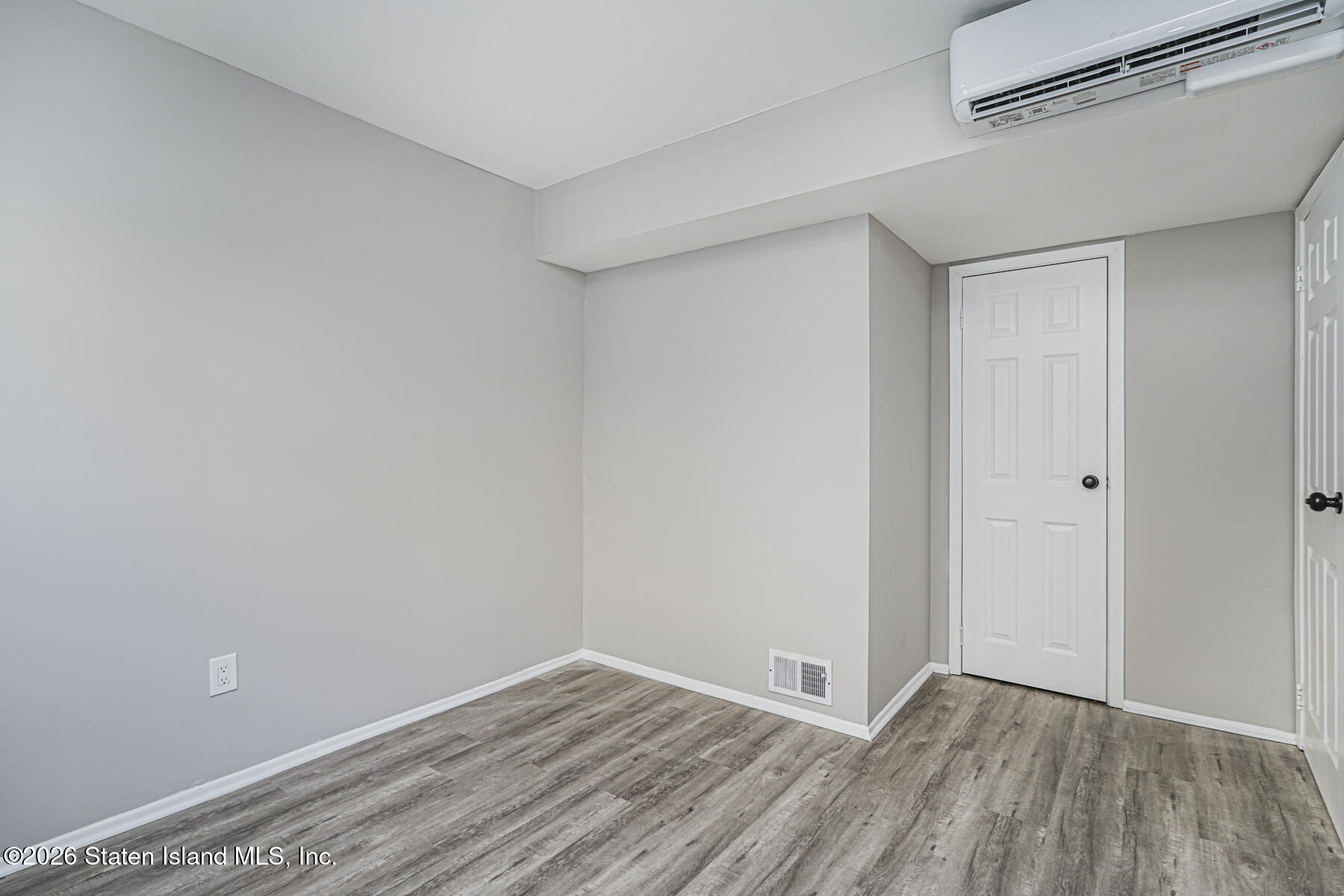 39 Commerce Street Staten Island, NY 10314 - Photo 46 of 49 a view of an empty room with wooden floor