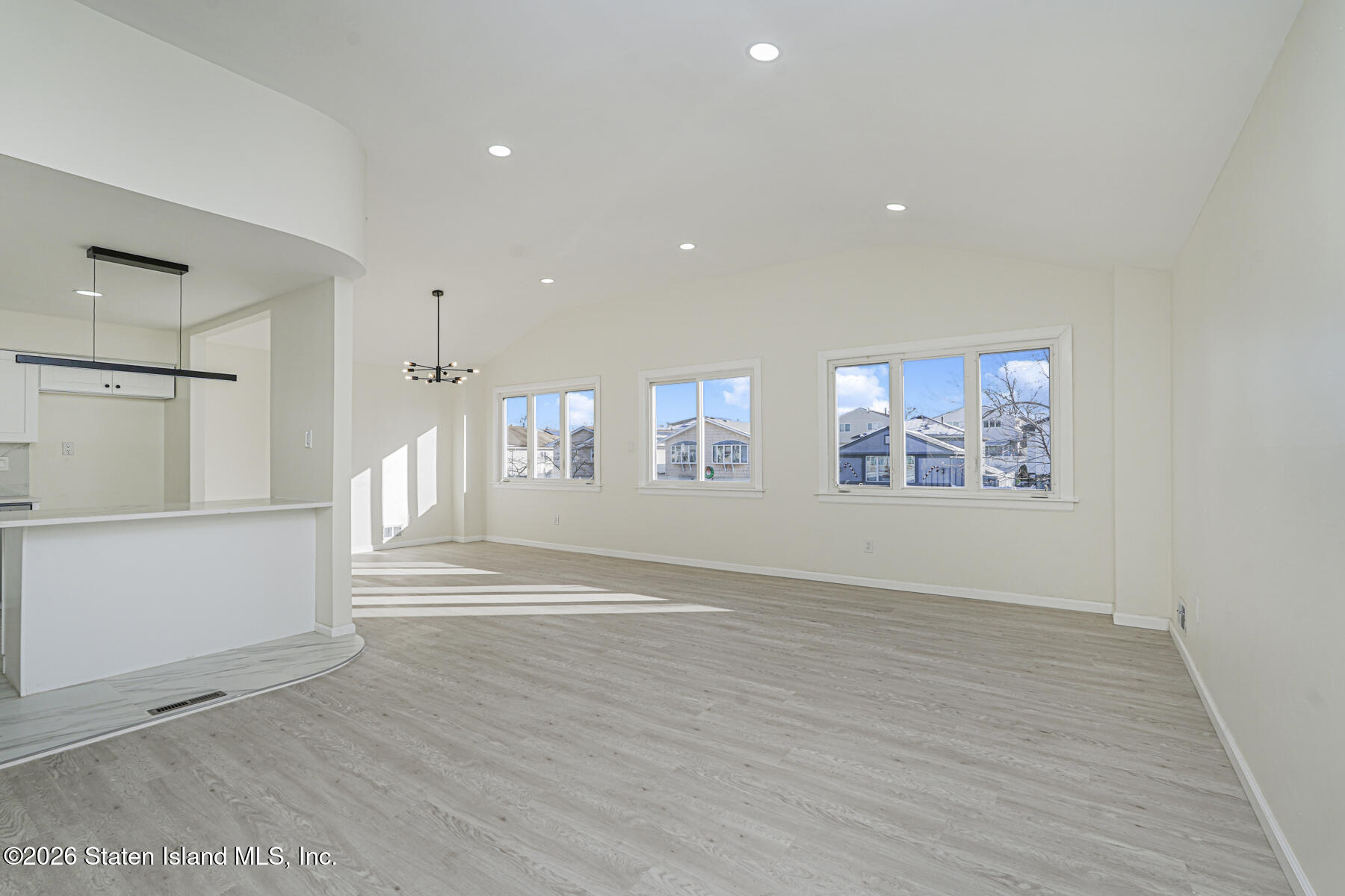 39 Commerce Street Staten Island, NY 10314 - Photo 8 of 49 a view of an empty room with wooden floor and a window
