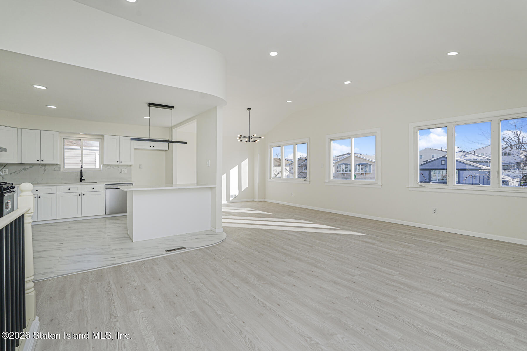 39 Commerce Street Staten Island, NY 10314 - Photo 9 of 49 a view of open kitchen with white cabinets and wooden floor