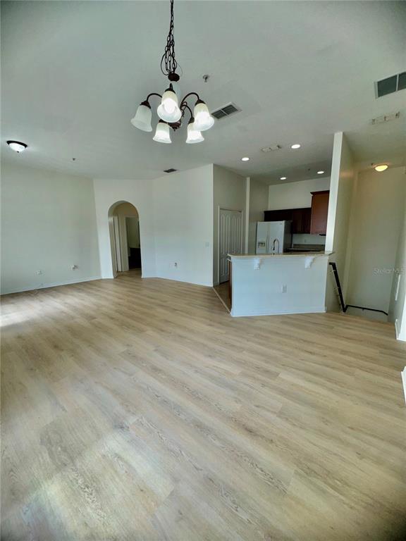 6404 South Goldenrod Road, Unit 2A Orlando, FL 32822 - Photo 37 of 40 a view of an empty room with a chandelier