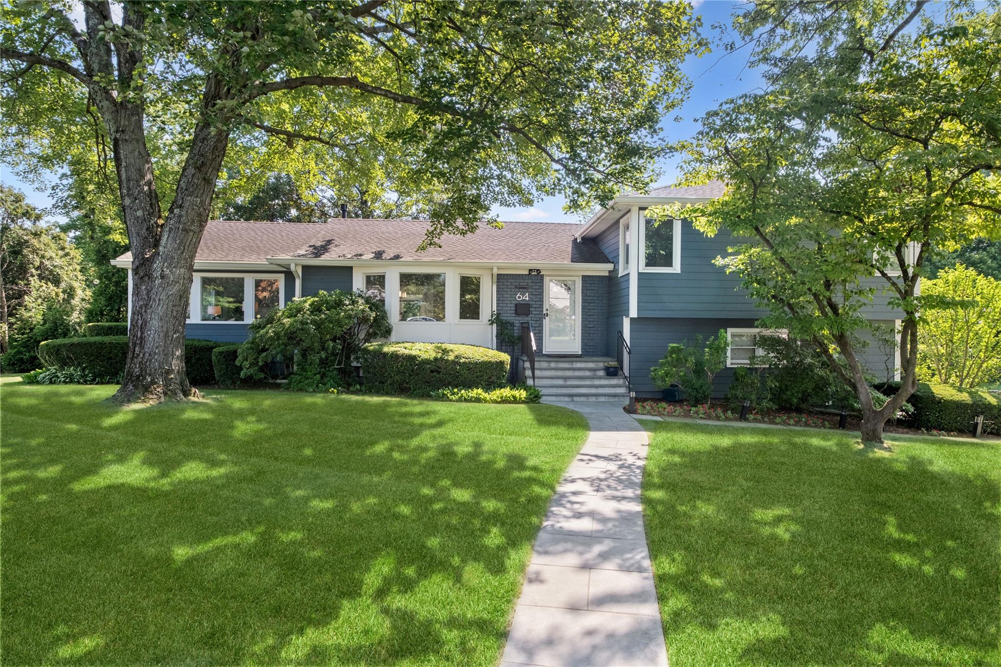 64 Richbell Road White Plains, NY 10605 - Photo 1 of 1 a front view of a house with a garden