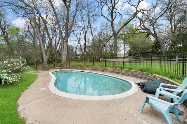 a view of a swimming pool and a yard