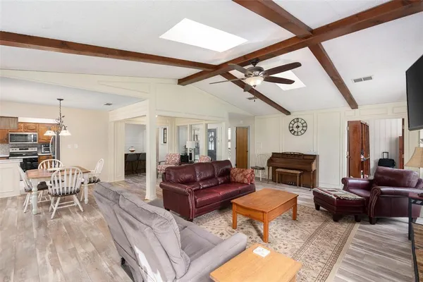 a living room with furniture a rug and a table