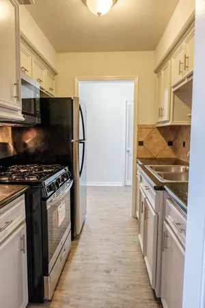 a kitchen with stainless steel appliances granite countertop a stove and a refrigerator