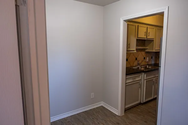 a kitchen with a refrigerator and a stove top oven