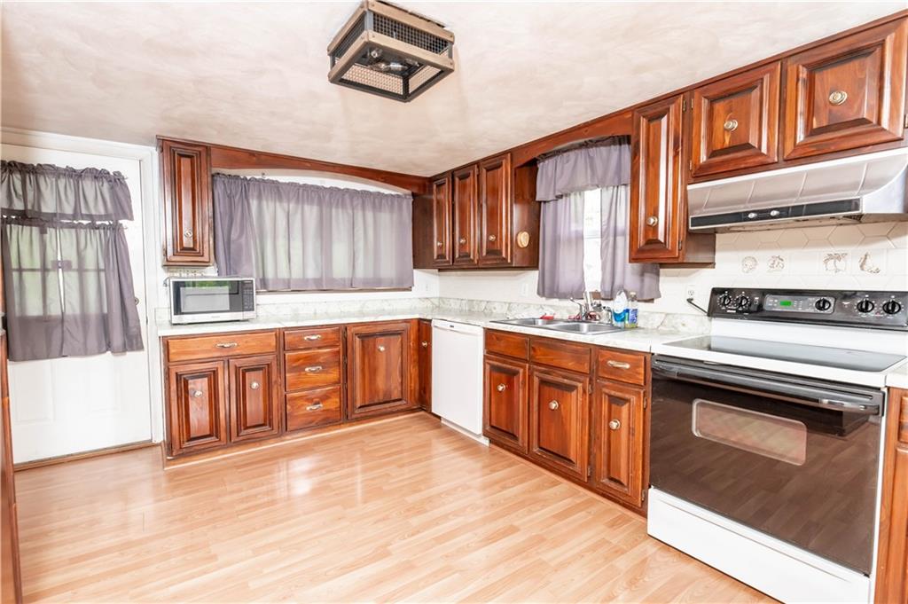 105 Dark Hollow Road Indiana, PA 15701 - Photo 18 of 44 a kitchen with stainless steel appliances granite countertop a stove sink and cabinets