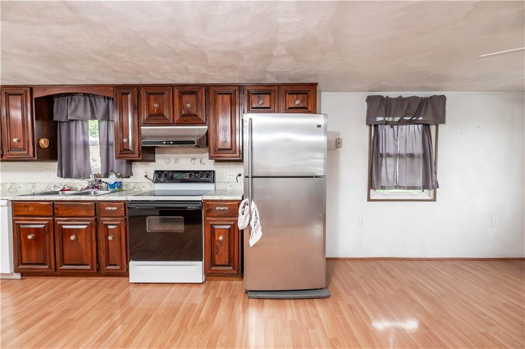 105 Dark Hollow Road Indiana, PA 15701 - Photo 20 of 44 a kitchen with stainless steel appliances granite countertop a refrigerator and a stove top oven