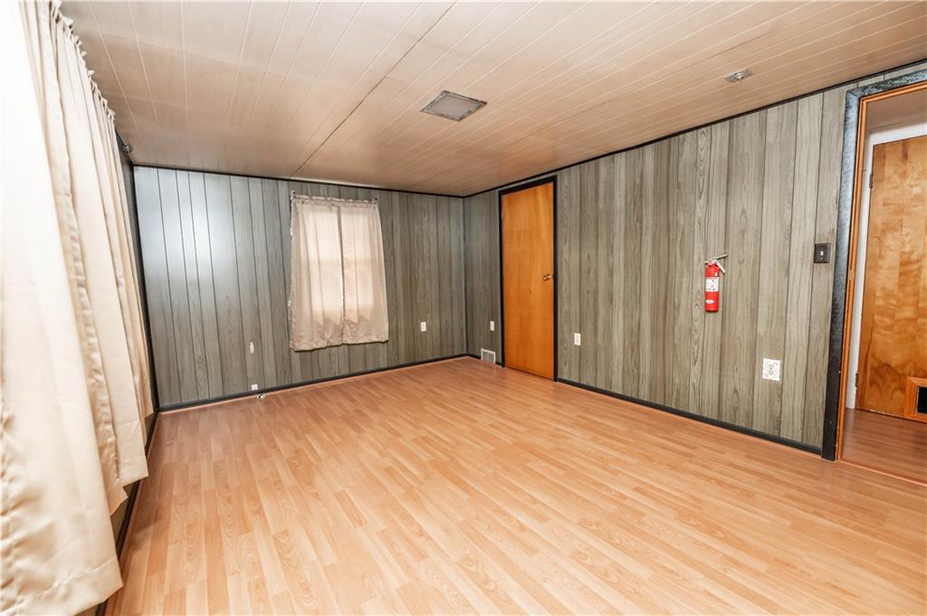105 Dark Hollow Road Indiana, PA 15701 - Photo 35 of 44 an empty room with wooden floor and windows