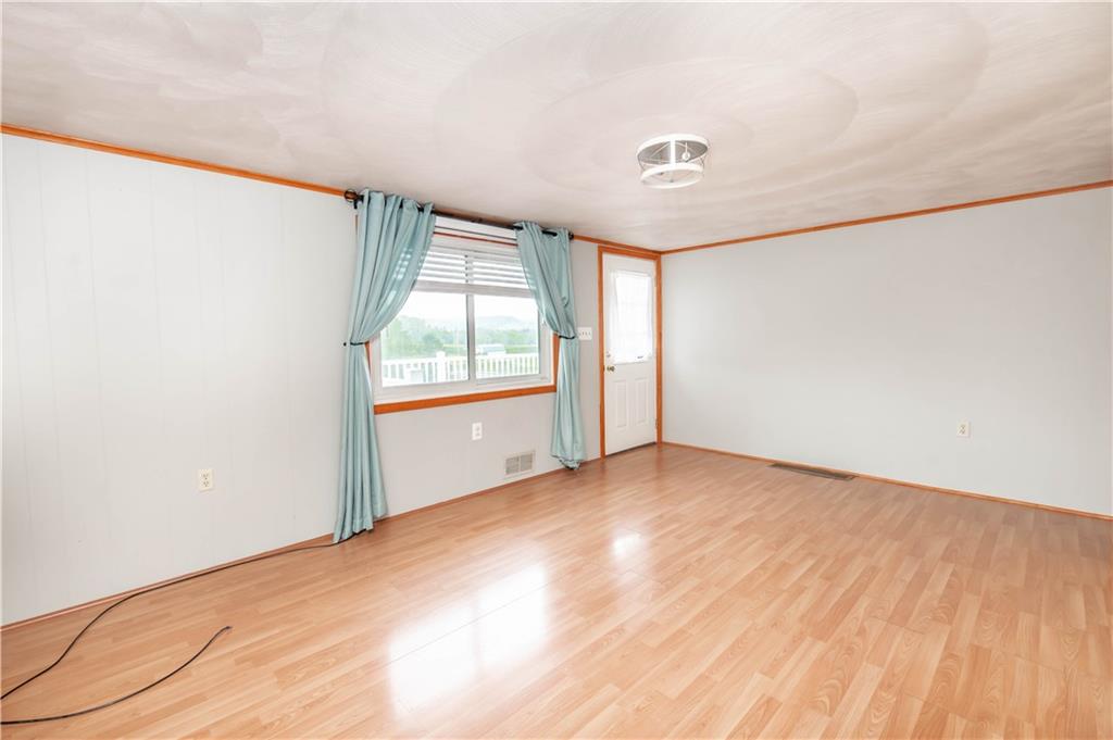 105 Dark Hollow Road Indiana, PA 15701 - Photo 40 of 44 an empty room with wooden floor and windows
