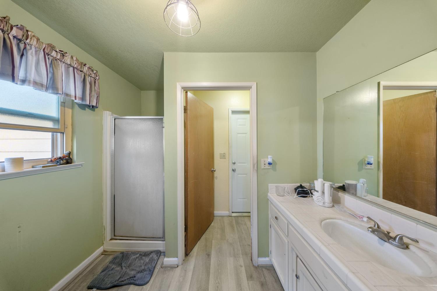 2779 Story Avenue Merced, CA 95340 - Photo 14 of 27 a bathroom with a tub sink and mirror