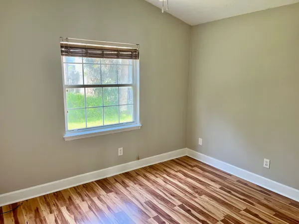 a view of a room with wooden floor and window